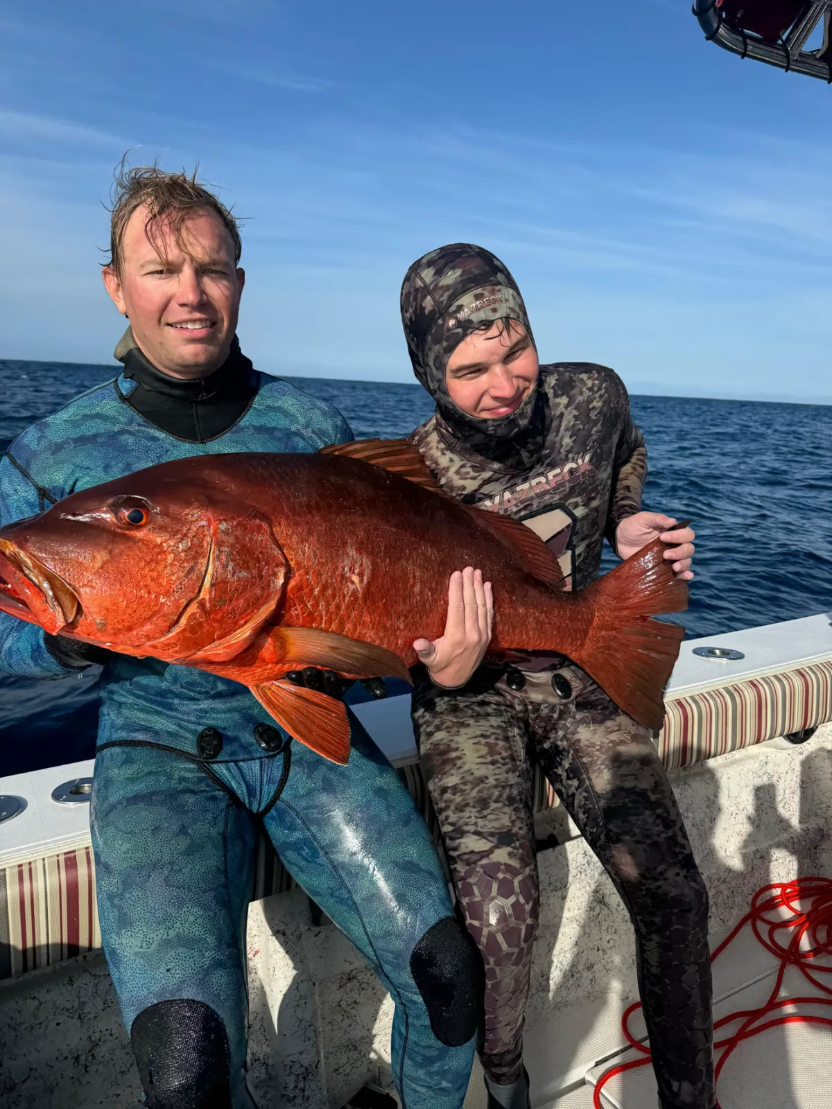 Spearo surfacing with a trophy reef fish on a Pacific Reef Level 2 dive