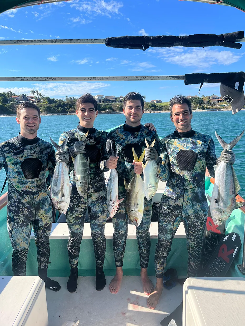 Spearfishing Level 1 guest entering the water with a speargun off Punta Mita